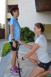 Physical therapist sizing woman for a cane
