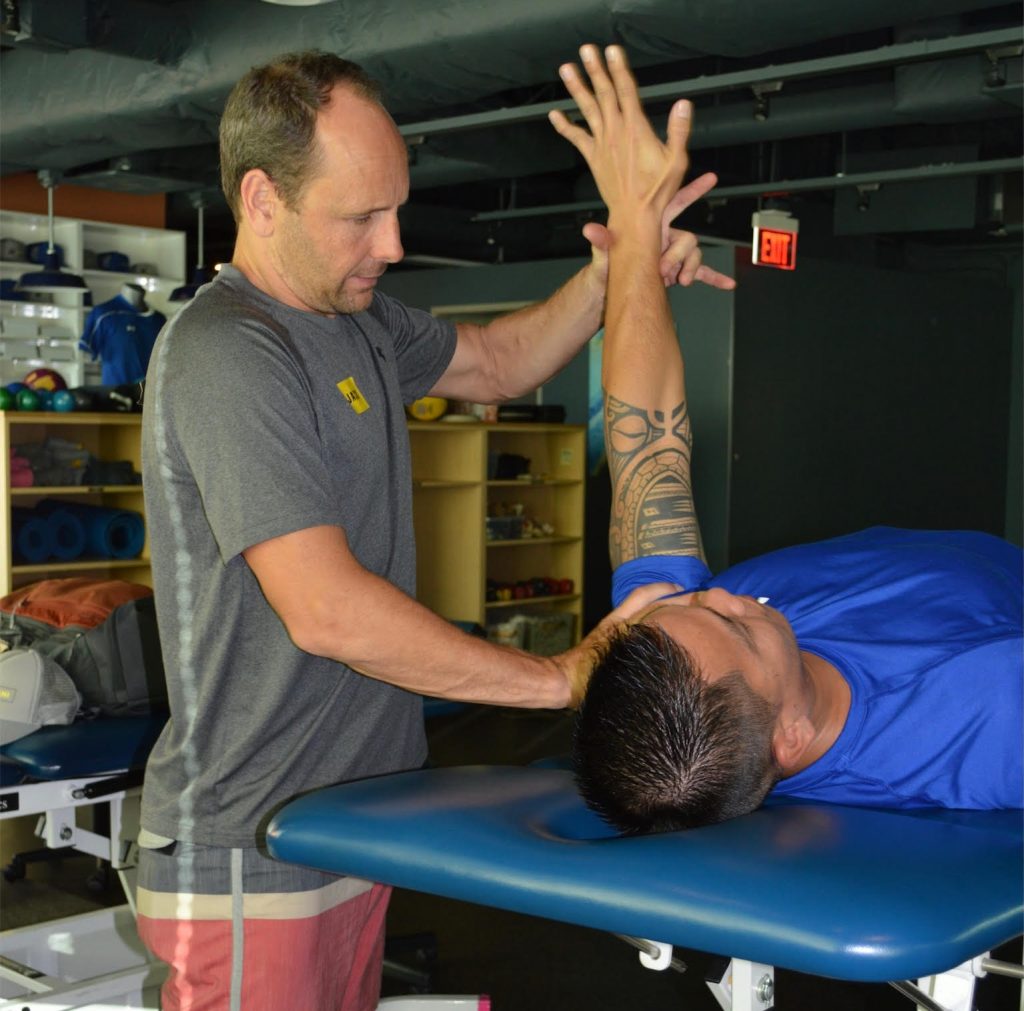 Physical therapist treating a shoulder injury