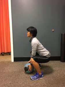 Woman demonstrating a squat