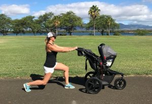 Woman is lunging while pushing a baby stroller outside