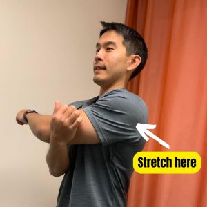 Person performing stretch for posterior shoulder