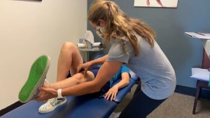 Woman treating a patient's knee