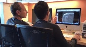 Two physical therapists looking at an MRI
