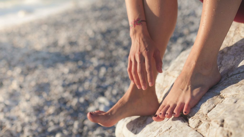 Person's feet on a stony beach
