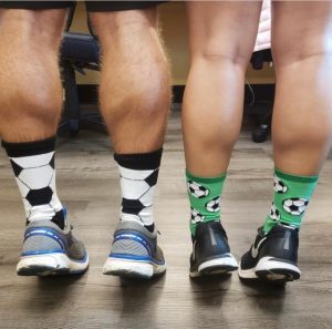 Two people doing calf raises in silly socks