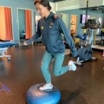 Woman hopping onto half BOSU with one leg