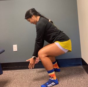 Woman squatting to lift off the ground